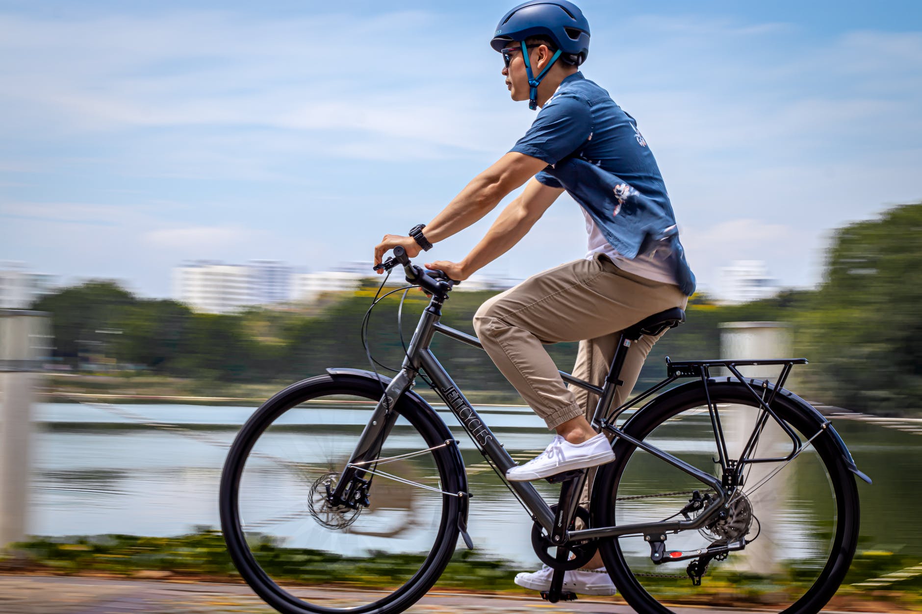 man in blue shirt riding a bicycle