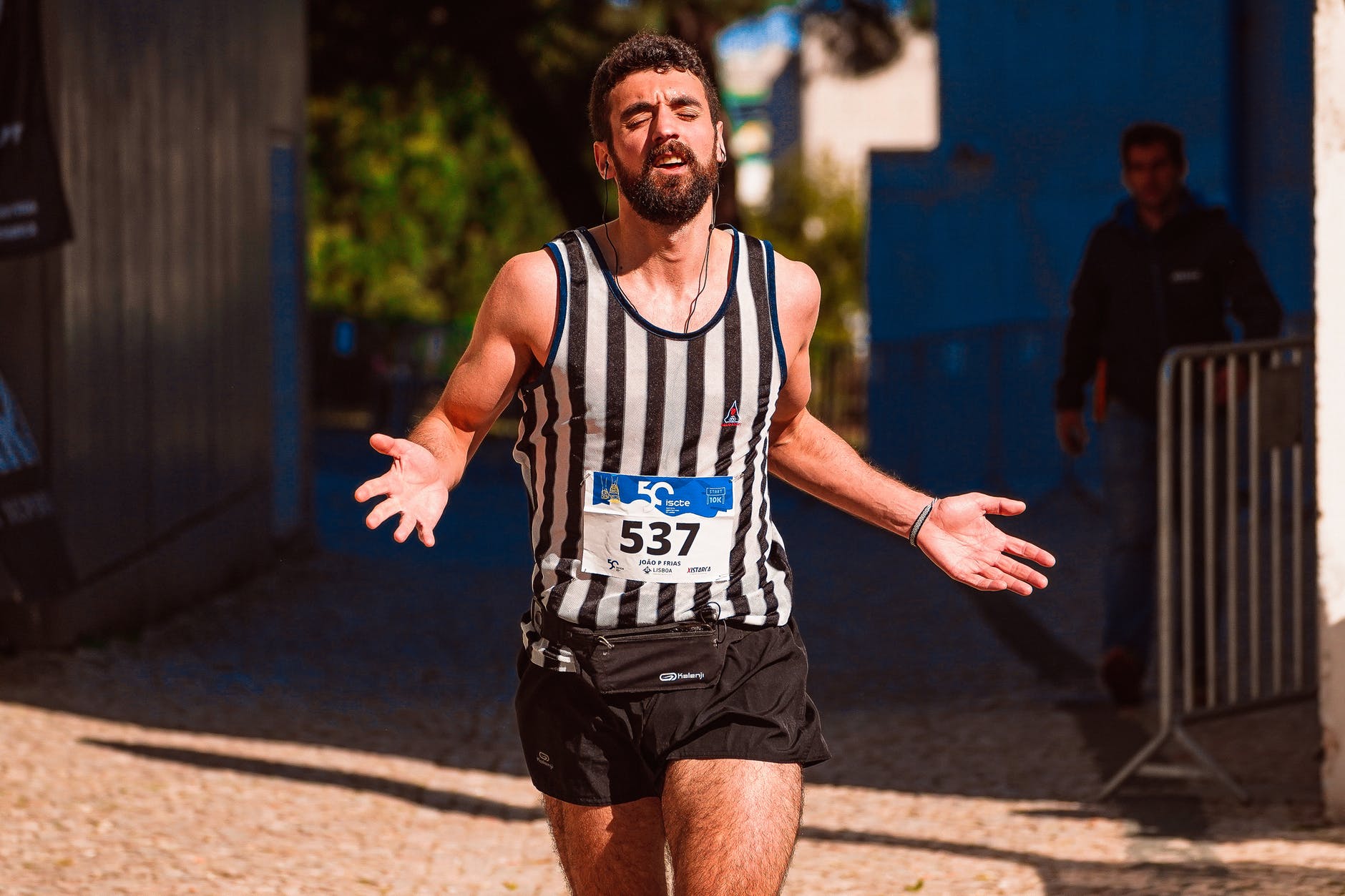 a runner running while wearing earphones