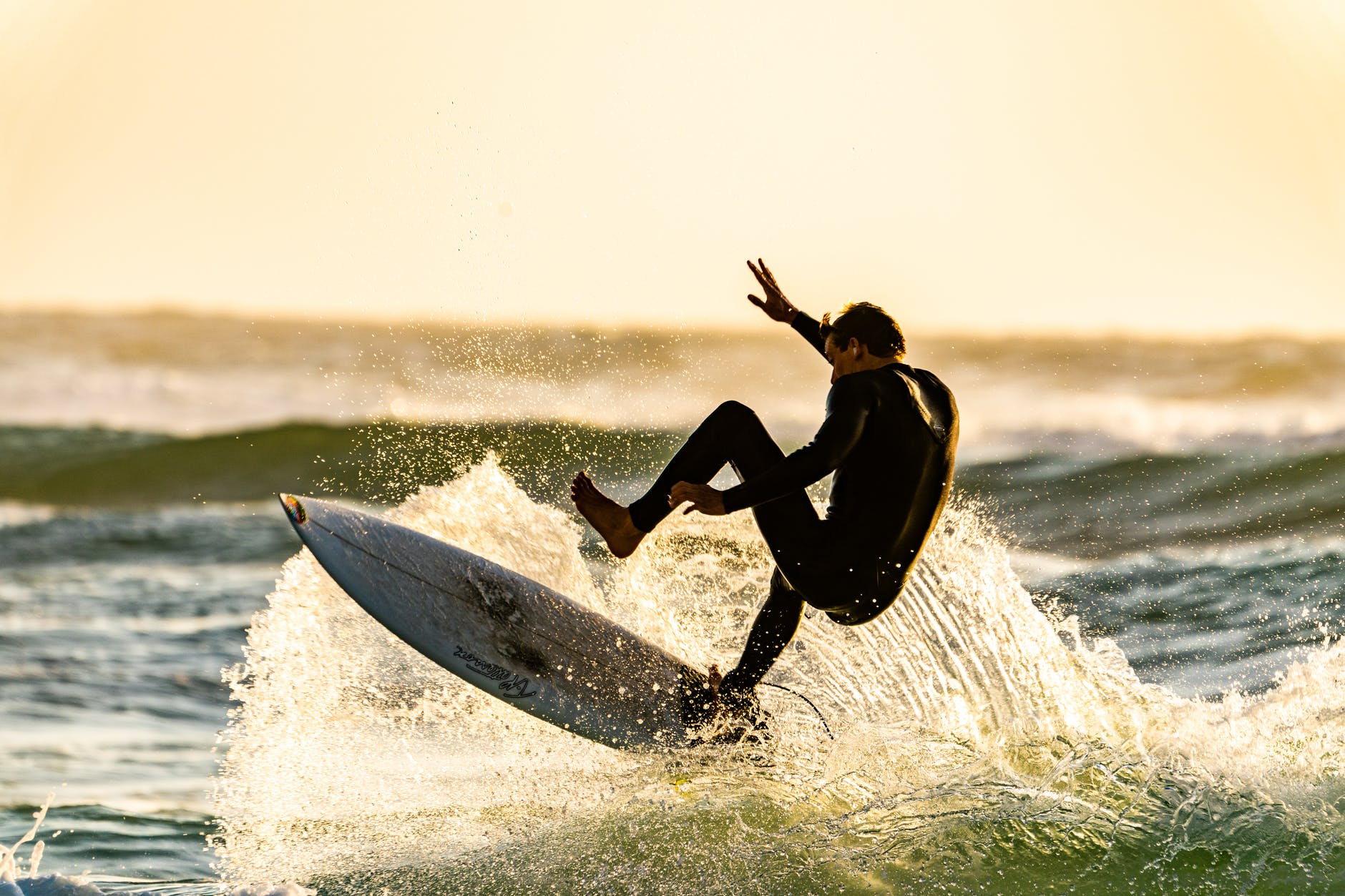 man about to wipeout of his surfboard