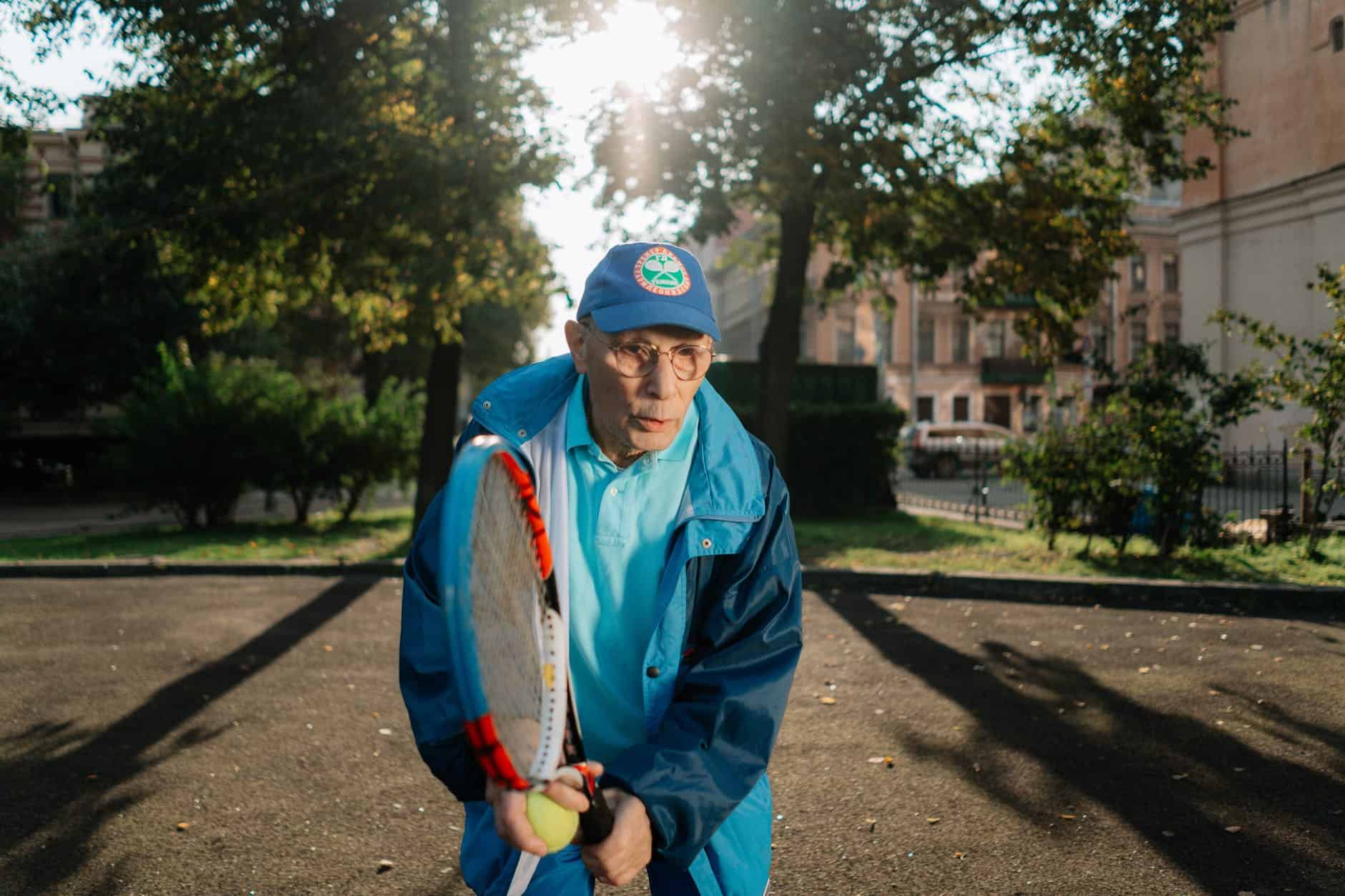 elderly man playing tennis