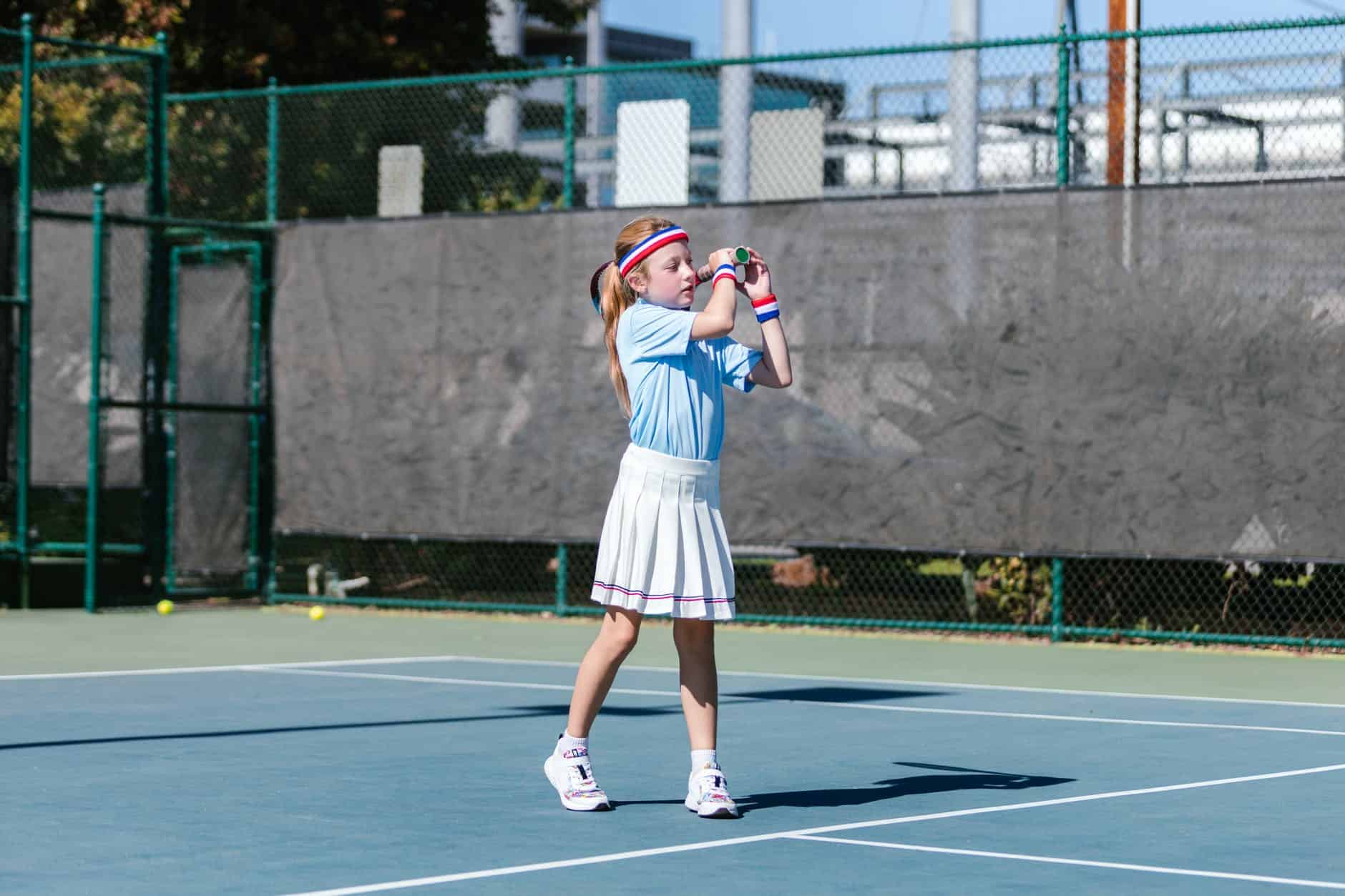 girl playing tennis