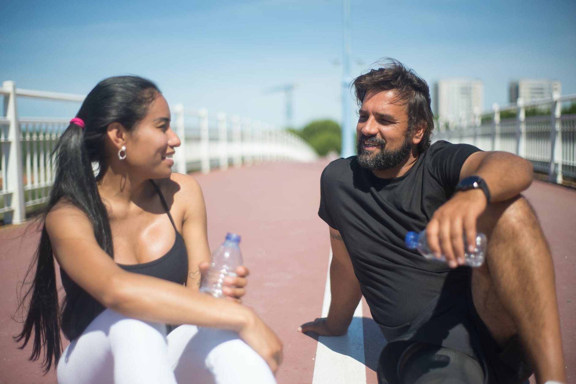 a man and a woman sitting on the ground