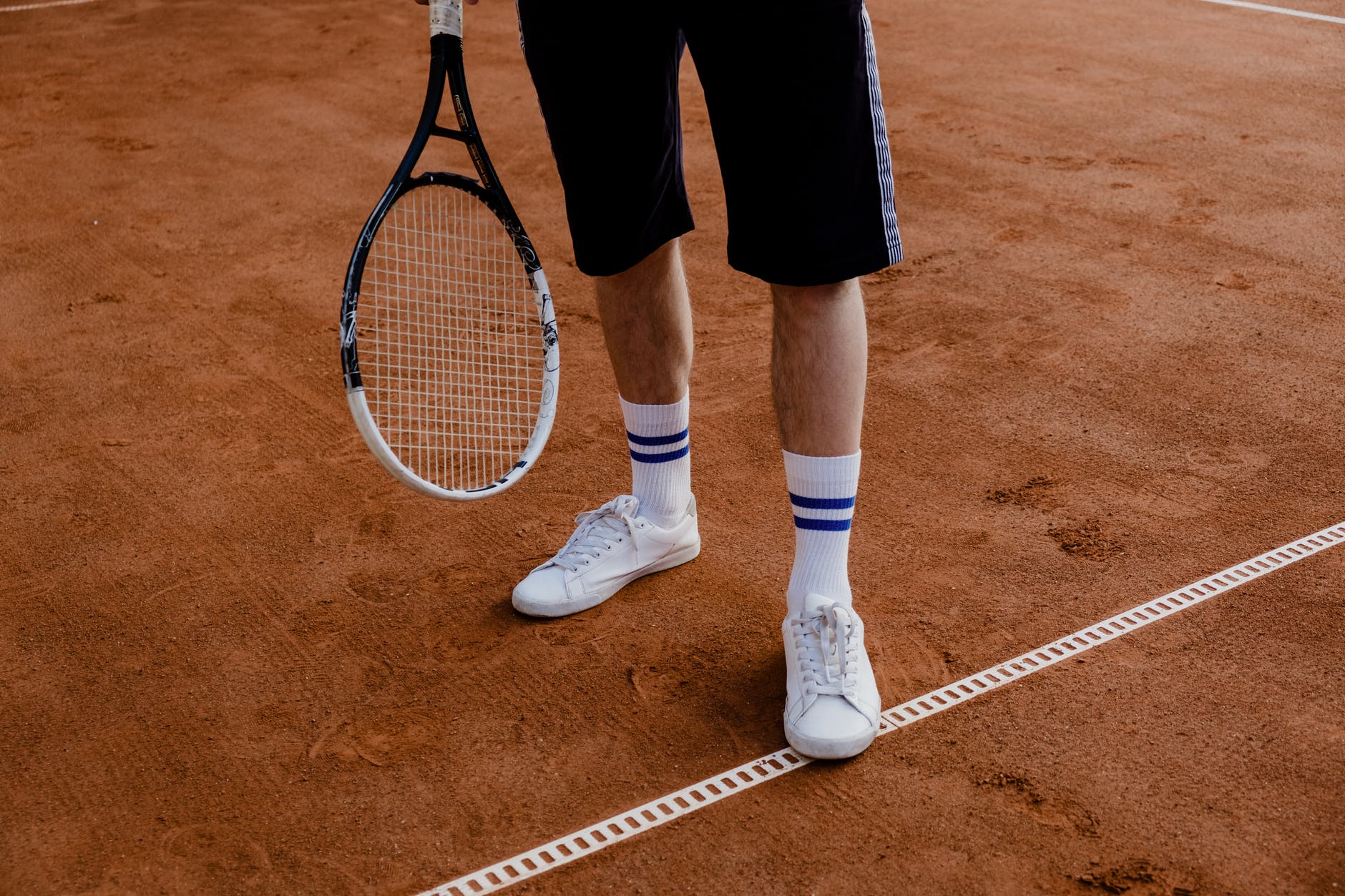 a man holding a tennis racket